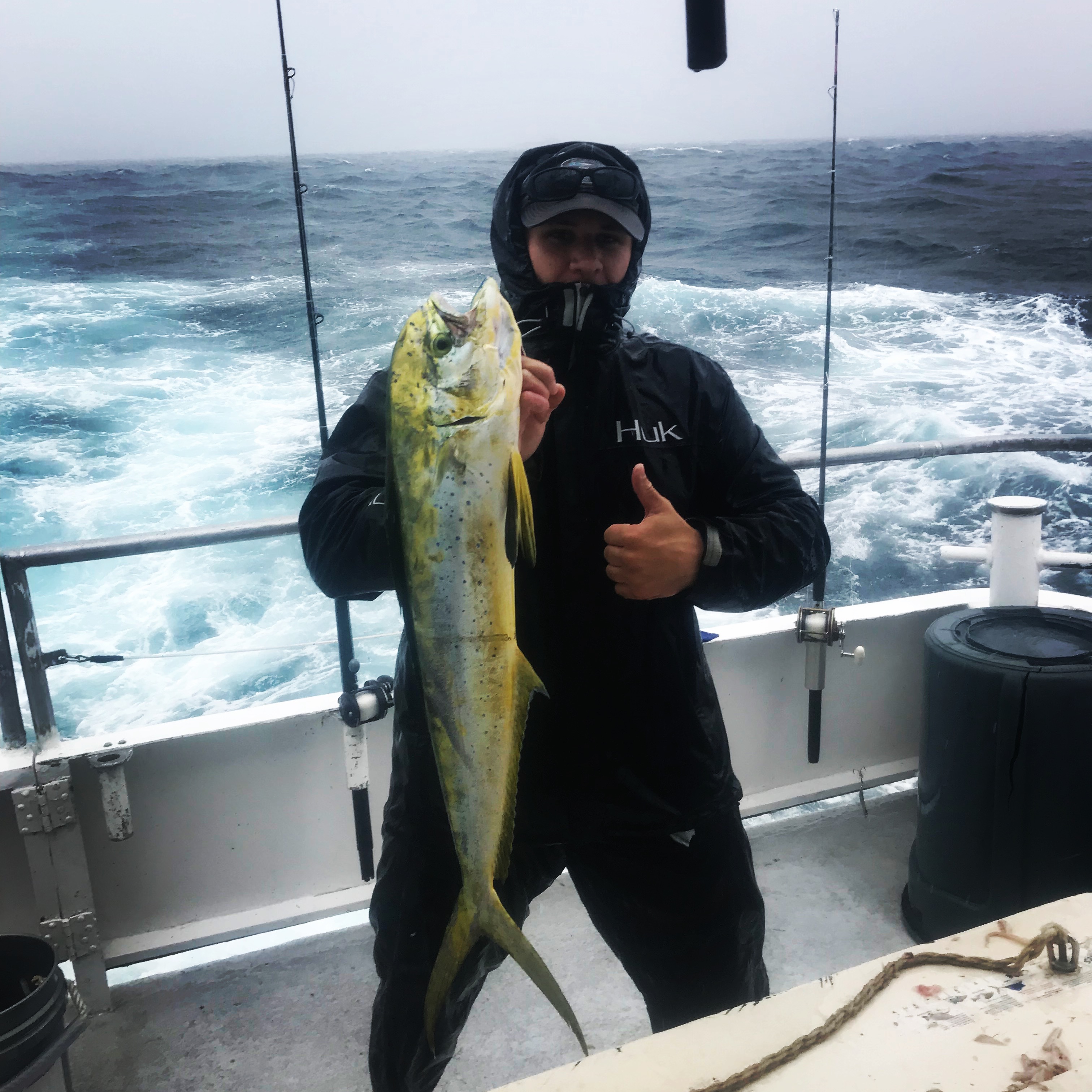 https://www.fishheadquarters.com/wp-content/uploads/2017/11/Evan-with-a-nice-dolphin-caught-on-a-rainy-day-aboard-Catch-My-Drift.jpg
